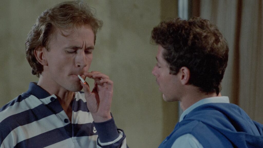 Mark Soper smoking a marijuana cigarette in Blood Rage (1984)